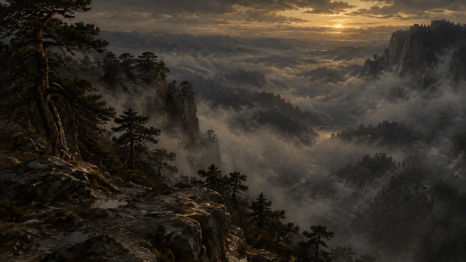 A high ridge looking down into a valley filled with mist at dusk.